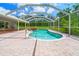 Beautiful screened pool and spa with brick paver decking and lush landscaping at 28628 Bennington Dr, Wesley Chapel, FL 33544