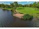 A waterfront deck extends into the lake, providing a peaceful spot to relax and enjoy the scenery at 3022 Forest Club Dr, Plant City, FL 33566