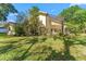 Exterior view of the house and the screened in patio with a backyard at 3022 Forest Club Dr, Plant City, FL 33566