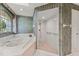 Bathroom with a soaking tub, walk-in shower, and green and white striped wallpaper at 3022 Forest Club Dr, Plant City, FL 33566
