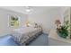 Cozy bedroom with floral bedding, white furniture, ceiling fan, and a view of the outdoors at 3022 Forest Club Dr, Plant City, FL 33566