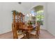 Bright dining area with a wooden table, decorative china cabinet, and a large window that provides plenty of natural light at 3022 Forest Club Dr, Plant City, FL 33566