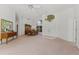 Open-concept living and dining area with neutral carpet, tall windows, and a chandelier for an inviting atmosphere at 3022 Forest Club Dr, Plant City, FL 33566