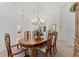 Elegant dining area featuring a wooden table, a chandelier, and decoratively-carved wooden china cabinet at 3022 Forest Club Dr, Plant City, FL 33566
