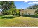 Charming home with a well-kept lawn, featuring palm trees and lush landscaping enhancing the curb appeal at 3022 Forest Club Dr, Plant City, FL 33566