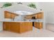 The kitchen features wood cabinets, a light countertop, and a skylight for abundant natural light and a clean design at 3022 Forest Club Dr, Plant City, FL 33566