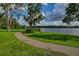 A picturesque path winds through the park's green lawn, offering tranquil lake views at 3022 Forest Club Dr, Plant City, FL 33566