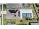 An aerial view showcases solar panels and a screened pool, highlighting the home's energy efficiency and outdoor living at 31649 Tansy Bnd, Wesley Chapel, FL 33545