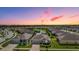 Aerial view of a residential neighborhood with well-maintained homes, ponds, and lush landscaping at 31649 Tansy Bnd, Wesley Chapel, FL 33545