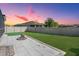Spacious backyard featuring a paver patio, lush green grass, and a secure fence for privacy at 31649 Tansy Bnd, Wesley Chapel, FL 33545