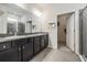 Bathroom features dual vanities, a large mirror, and a separate glass-enclosed shower at 31649 Tansy Bnd, Wesley Chapel, FL 33545