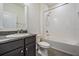 Clean bathroom featuring a vanity with granite top and a shower over tub and gray tile at 31649 Tansy Bnd, Wesley Chapel, FL 33545