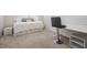Cozy bedroom featuring carpet, a comfortable bed, and a functional desk area at 31649 Tansy Bnd, Wesley Chapel, FL 33545
