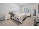 Comfortable bedroom with carpet flooring, a large window, and stylish decor at 31649 Tansy Bnd, Wesley Chapel, FL 33545