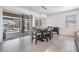 Bright dining area with tile flooring, a modern chandelier, and views of the pool at 31649 Tansy Bnd, Wesley Chapel, FL 33545