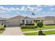 Inviting single-story home showcases stone detailing, a two-car garage, and a manicured front lawn at 31649 Tansy Bnd, Wesley Chapel, FL 33545