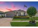 Charming single-story home features a well-manicured lawn, stone accents, and an attached two-car garage at 31649 Tansy Bnd, Wesley Chapel, FL 33545