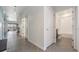 A bright hallway with tiled floors and direct access to the full bathroom at 31649 Tansy Bnd, Wesley Chapel, FL 33545