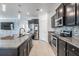 Modern kitchen boasts granite countertops, stainless steel appliances, and dark cabinetry at 31649 Tansy Bnd, Wesley Chapel, FL 33545