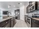 Modern kitchen boasts granite countertops, stainless steel appliances, and dark cabinetry at 31649 Tansy Bnd, Wesley Chapel, FL 33545