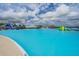 A clear-water lagoon featuring water slides and inflatable obstacles, perfect for Gathering fun and recreation at 31649 Tansy Bnd, Wesley Chapel, FL 33545