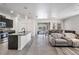 An open-concept living area features a kitchen, dining space, and access to the screened pool, perfect for entertaining at 31649 Tansy Bnd, Wesley Chapel, FL 33545