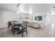 Open floor plan featuring a stone accent wall, modern furniture, and adjacent dining area at 31649 Tansy Bnd, Wesley Chapel, FL 33545