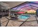 Enclosed patio features a pool and hot tub, with a built in kitchen and bar area at 31649 Tansy Bnd, Wesley Chapel, FL 33545