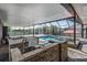 Stunning screened-in pool with an outdoor kitchen and bar perfect for entertaining guests at 31649 Tansy Bnd, Wesley Chapel, FL 33545