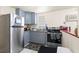 Efficient kitchen with stainless steel appliances, granite countertops, and blue cabinets at 3310 70Th N Ave, St Petersburg, FL 33702