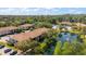 An aerial view of the community featuring ponds, mature trees and lush landscaping at 3380 Crystal Court E # G, Palm Harbor, FL 34685