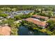 Aerial view of the community featuring ponds, manicured landscaping, tennis courts, and pool at 3380 Crystal Court E # G, Palm Harbor, FL 34685