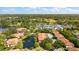 Overhead view of community including pool, tennis courts, manicured grounds, and complex buildings at 3380 Crystal Court E # G, Palm Harbor, FL 34685