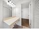 Bathroom vanity with a big mirror, drawers, and access to the walk-in closet at 3380 Crystal Court E # G, Palm Harbor, FL 34685
