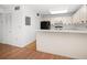 This kitchen has white cabinets and a black refrigerator, with light entering from the window at 3380 Crystal Court E # G, Palm Harbor, FL 34685