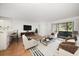Bright living room with stylish furniture, wood floors, and sliding glass doors to the porch at 3380 Crystal Court E # G, Palm Harbor, FL 34685