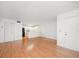 Spacious living space features wood-look flooring, with views of the kitchen and the front door at 3380 Crystal Court E # G, Palm Harbor, FL 34685