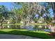 Scenic pond view showcasing lush greenery and an idyllic water feature in the community at 3380 Crystal Court E # G, Palm Harbor, FL 34685
