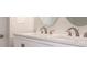 Bathroom featuring a dual sink vanity with modern fixtures and a clean, updated aesthetic at 5143 Jasmine Cir, St Petersburg, FL 33714