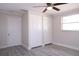 This bedroom features a ceiling fan, two closets, fresh paint and modern laminate flooring at 5143 Jasmine Cir, St Petersburg, FL 33714