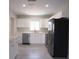 Modern kitchen features stainless steel appliances, white cabinets, and sleek countertops for a clean look at 5143 Jasmine Cir, St Petersburg, FL 33714