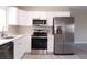 Well-equipped kitchen showcasing stainless steel appliances, white cabinetry, and ample counter space at 5143 Jasmine Cir, St Petersburg, FL 33714