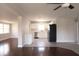 Bright living space blending wood and tile floors adjacent to a modern kitchen with stainless steel appliances at 5143 Jasmine Cir, St Petersburg, FL 33714