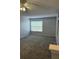 Spacious bedroom filled with natural light, thanks to the large window and a ceiling fan at 5904 Willow Ridge Dr # 202, Zephyrhills, FL 33541