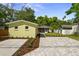 Backyard of yellow home showing detached building, paver patio, and manicured landscaping at 617 Scotland St, Dunedin, FL 34698