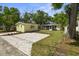 Aerial view of backyard featuring pavers, fresh grass and mulch, landscaping and main house and guest house at 617 Scotland St, Dunedin, FL 34698