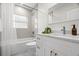Bright bathroom features a modern vanity and shower-tub combo at 617 Scotland St, Dunedin, FL 34698