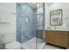 Stylish bathroom featuring modern vanity and frameless glass shower with blue tiling at 617 Scotland St, Dunedin, FL 34698