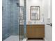 Modern bathroom featuring a frameless glass shower and sleek wood vanity at 617 Scotland St, Dunedin, FL 34698
