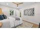 Bright bedroom featuring a ceiling fan, stylish rug, and modern wall art at 617 Scotland St, Dunedin, FL 34698